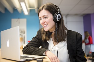 Woman with computer and headset