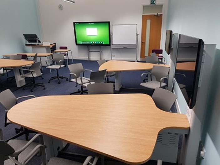 active learning classroom with group desks and chairs