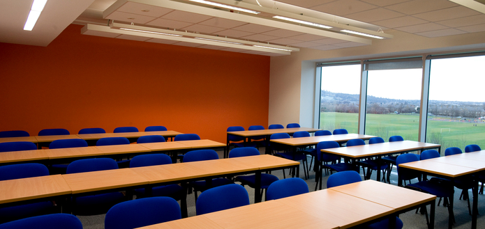 Classroom with tables and chairs in rows